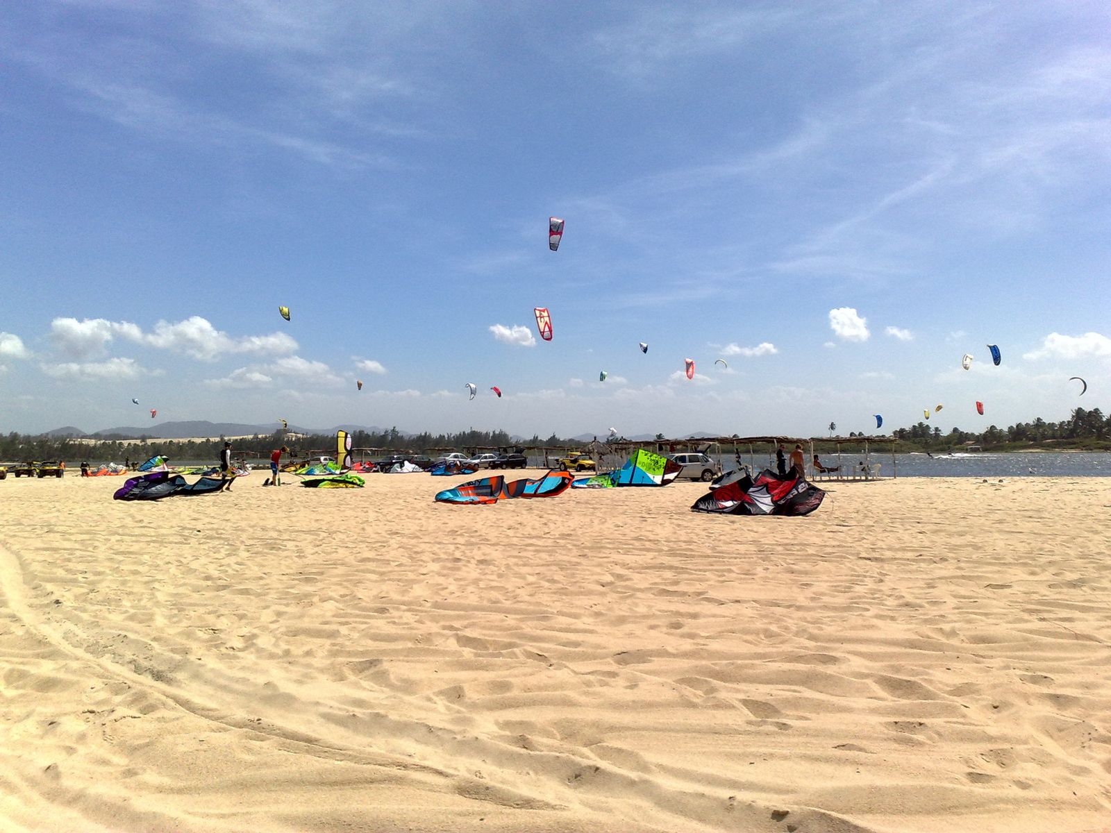 Kites rigged on the sand and flying over Cauípe in November.