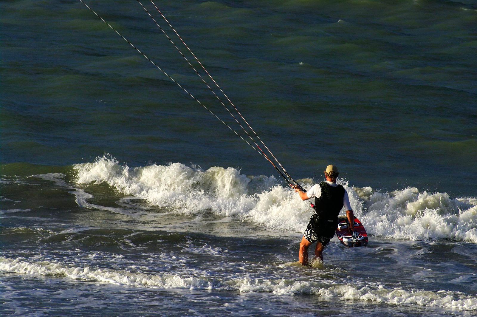 Wading out through the shorebreak on a July afternoon.