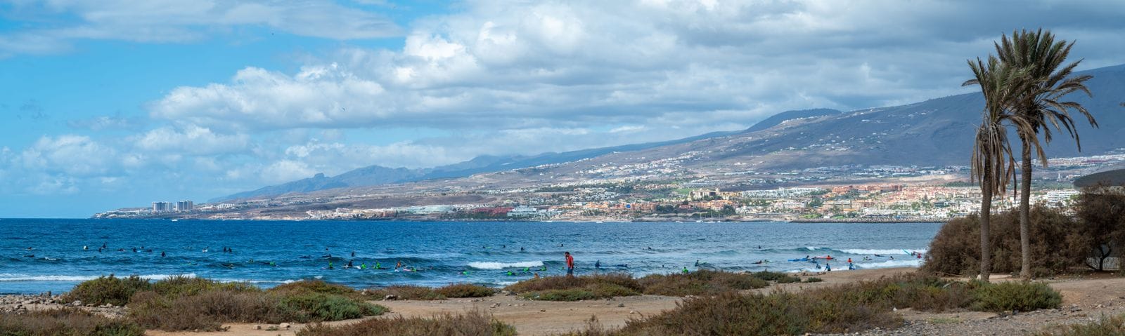 Surfers in the water off Playa de las Américas, October 2024.